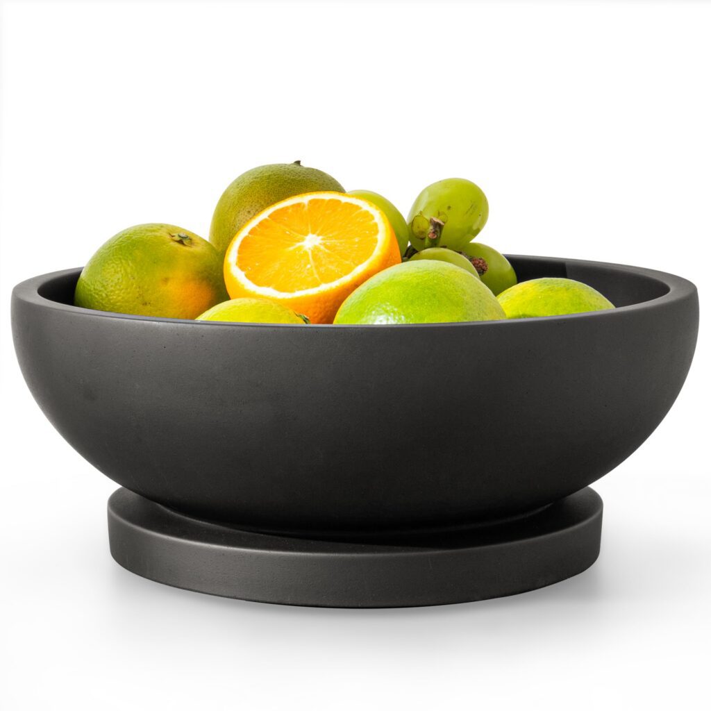 Bowl of mixed fruits including orange slice.