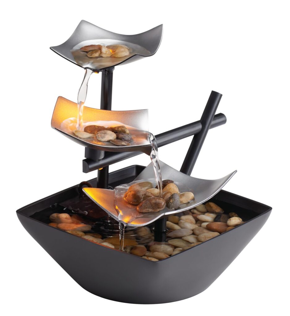 Tabletop fountain with cascading water and stones.