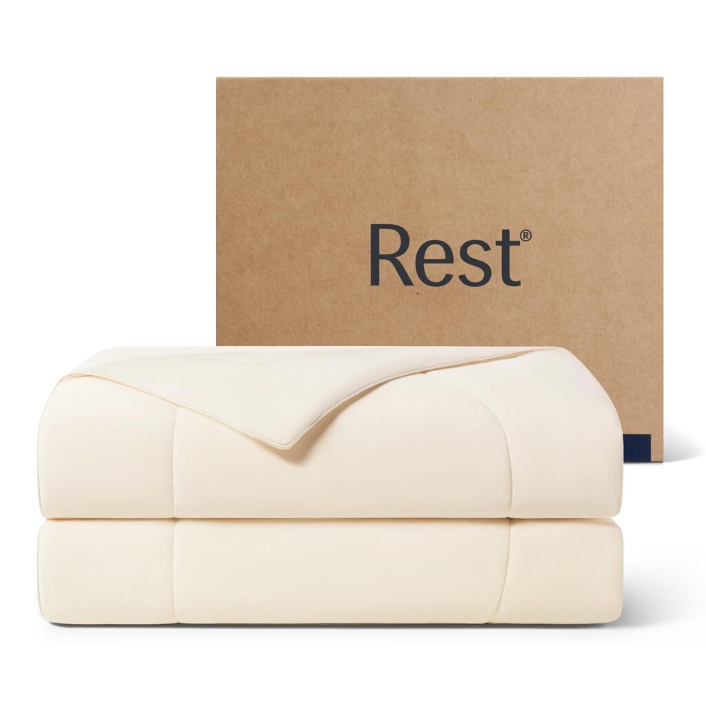 Folded comforter beside Rest branded box.