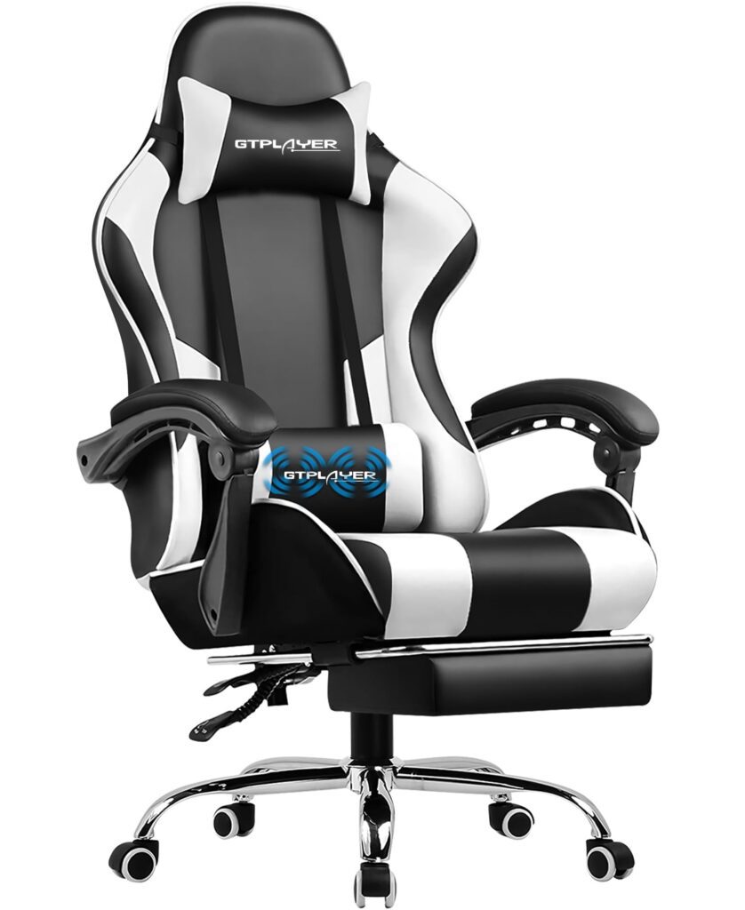 Black and white gaming chair with footrest.