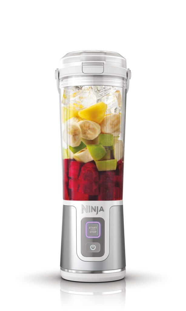Portable blender with fruits inside.