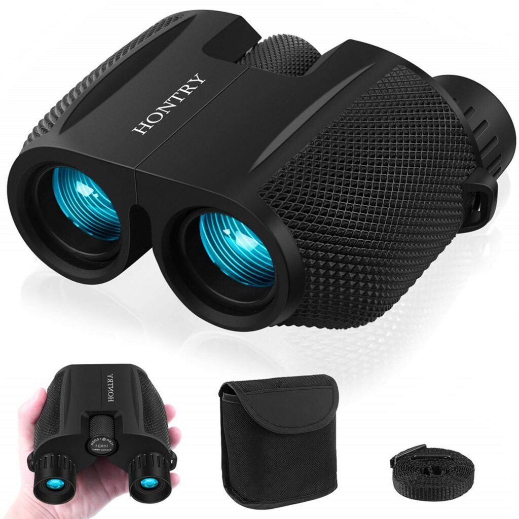 Compact black binoculars with accessories displayed.