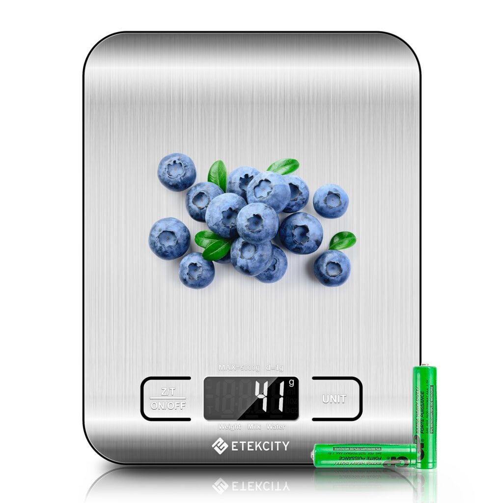 Digital kitchen scale with blueberries and batteries.